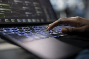 server-room-programmer-coding-laptop-typing-keyboard-close-up-scaled