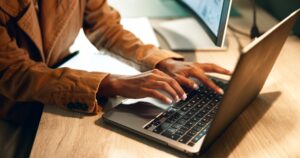 hands-woman-computer-online-work-dark-night-deadline-pressure-typing-journalist-female-person-office-rush-technology-project-headline-article-laptop-scaled